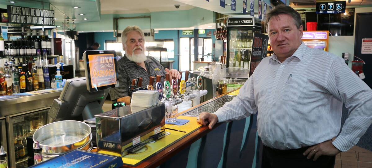 STRONG DETERRENT: Alex Moore with barman John Broadby at Munmorah United Bowling Club this week.  Picture: David Stewart
