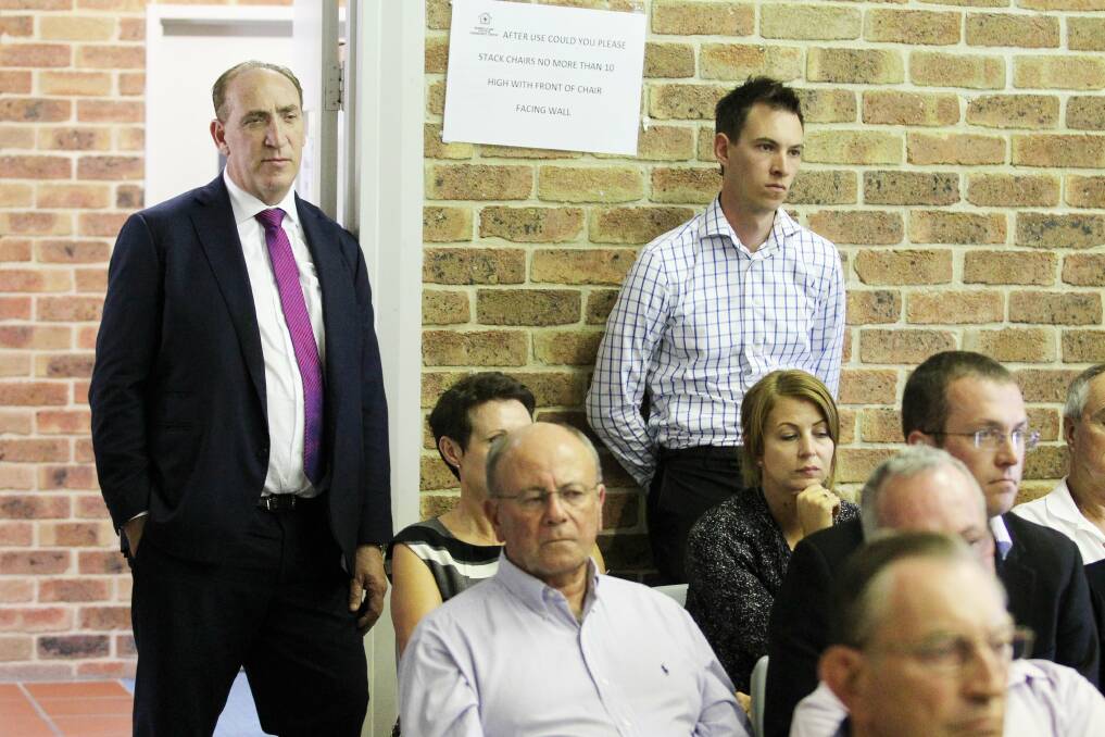 REACTING: Keith Johnson, left, listens to proceedings at the meeting. Picture: Max Mason-Hubers