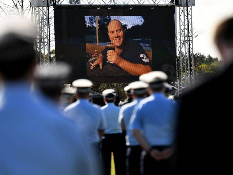 Senior Constable David Masters died after being hit by a suspected stolen car on the Bruce Highway. (Dan Peled/AAP PHOTOS)