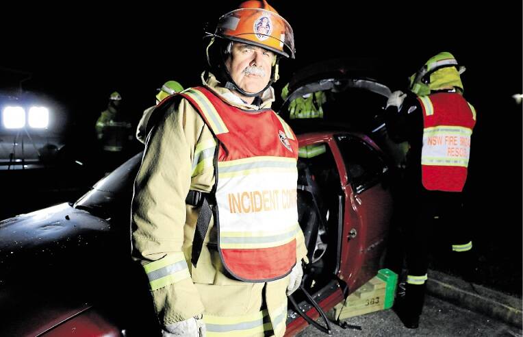 MOCK RESCUE: Captain Steve McNulty and his crew hone their skills on a car body at the Fire and Rescue NSW station at Morisset on Monday night. Picture: David Stewart