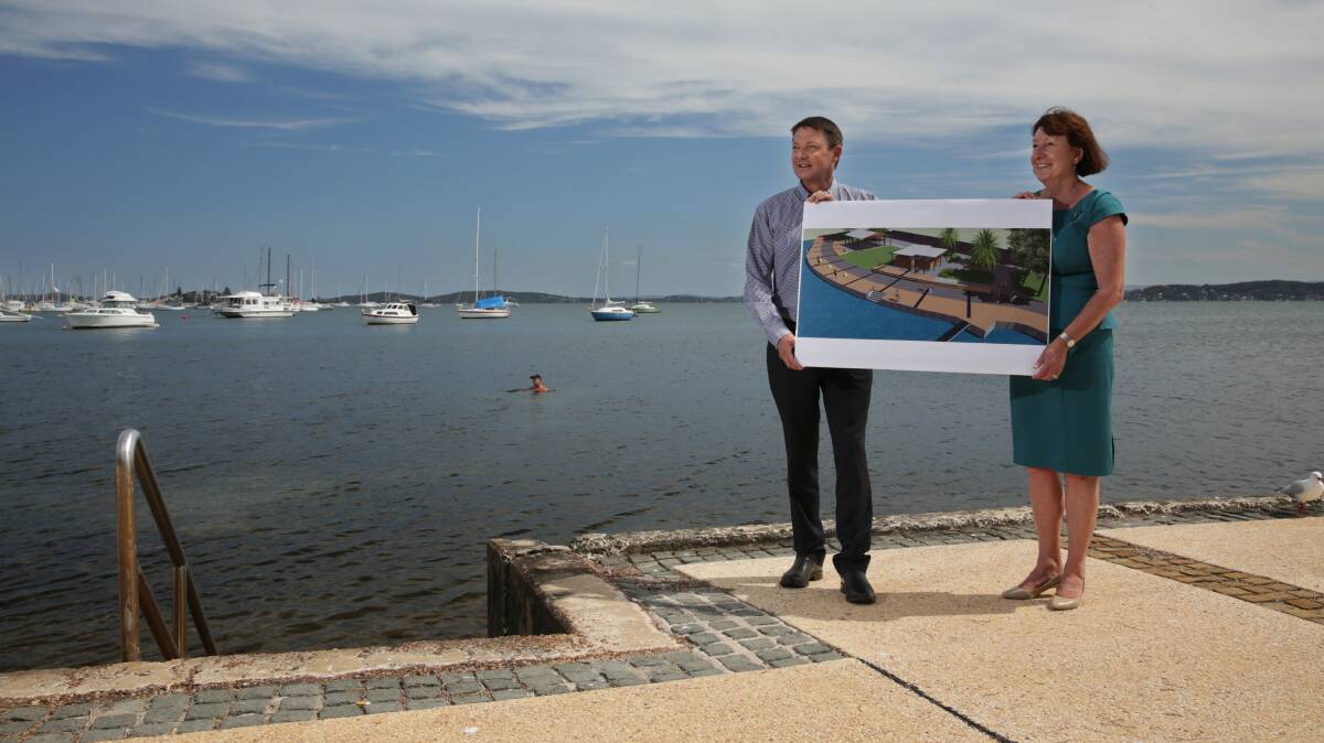 Funding boost: Parliamentary secretary for the Hunter Scot MacDonald and Lake Macquarie mayor Kay Fraser at the waterfront in Belmont with plans for the new-look Belmont Baths. Picture: Simone De Peak