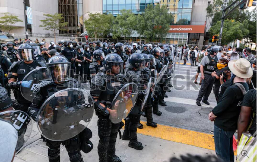 Police are militarised by their wearing of masks and carrying of shields. 