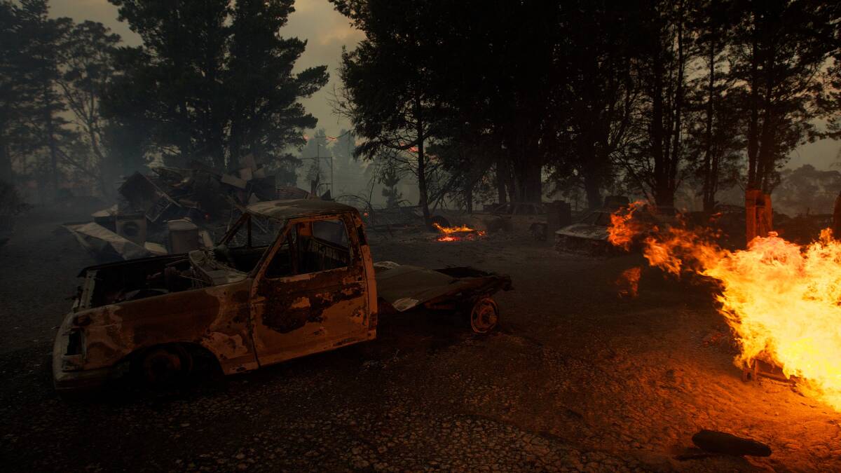 An out of control bushfire burns cars and two homes near Newnes Junction on the Bells Line of Road. Photo: WOLTER PEETERS