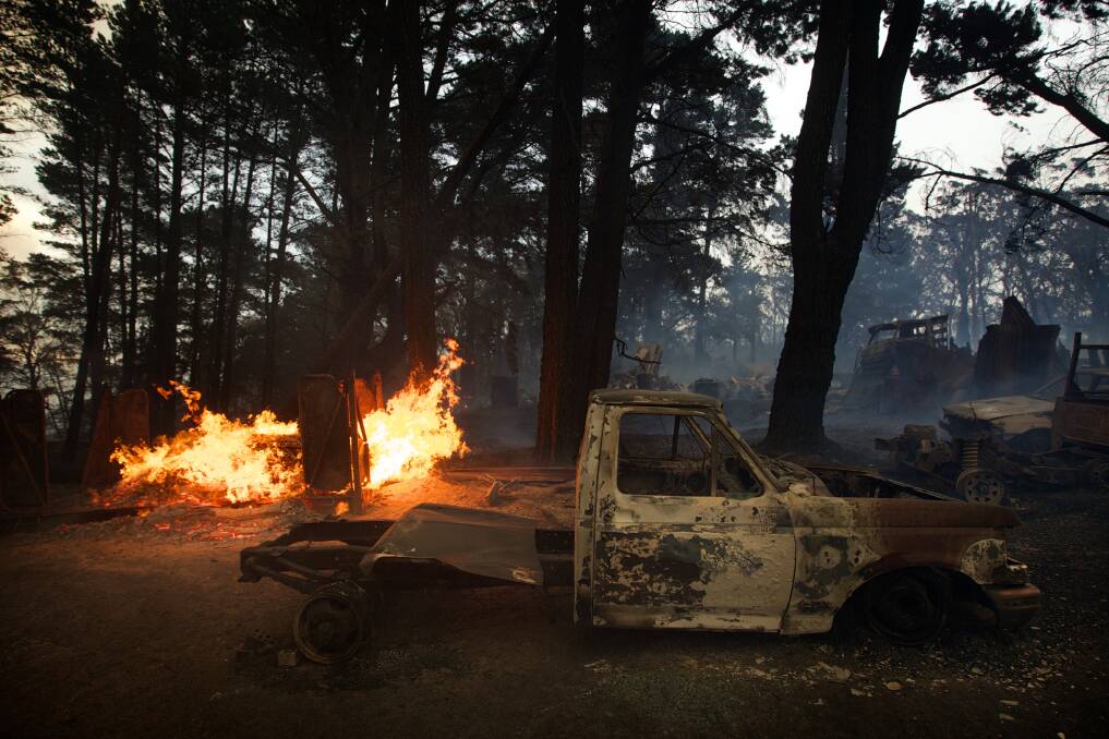 An out of control bushfire burns cars and two homes near Newnes Junction on the Bells Line of Road. Photo: WOLTER PEETERS