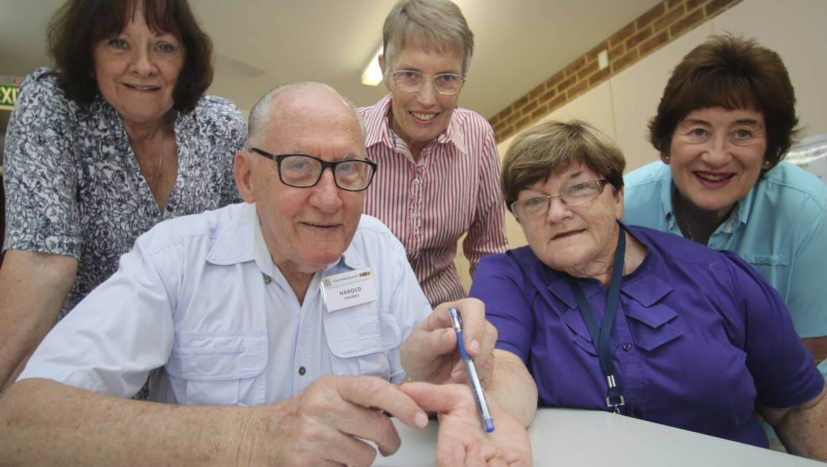 HANDS UP: Group leader Harold Franks gives a preview of his palm reading course to U3A Lake Macquarie president Carole Obre, while U3A members Jo Groth, left, and Penny Stanford look on. Picture: David Stewart