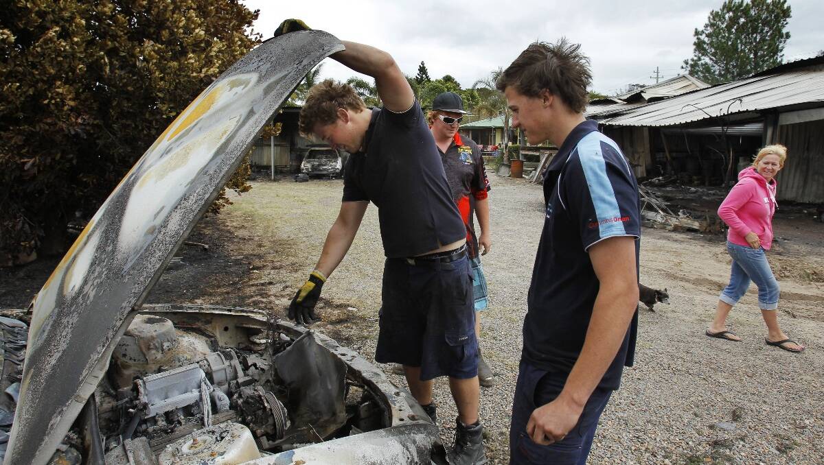 From left, Jesse Byrne, friend Brandon Vogtmann, Jack Byrne and Michelle Byrne lost their shed, two cars, a jet ski and Michelle's home dog grooming business in the Heatherbrae / Raymond Terrace / Medowie bush fire. Picture: Max Mason-Hubers