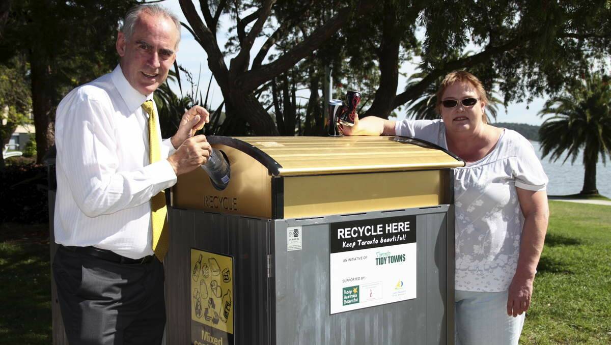 RECYCLE: Member for Lake Macquarie Greg Piper and Kelly Hoare at a recycling bin in the Regatta Walk Park.