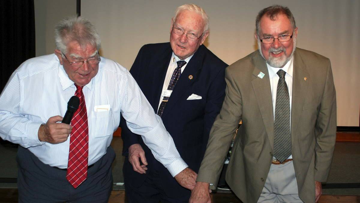 MILESTONE: Pictured at the cake cutting are (from left) Morisset Probus Club president Greg Riding, founding member Les Norris, and Morisset Rotary Club president John Olive.