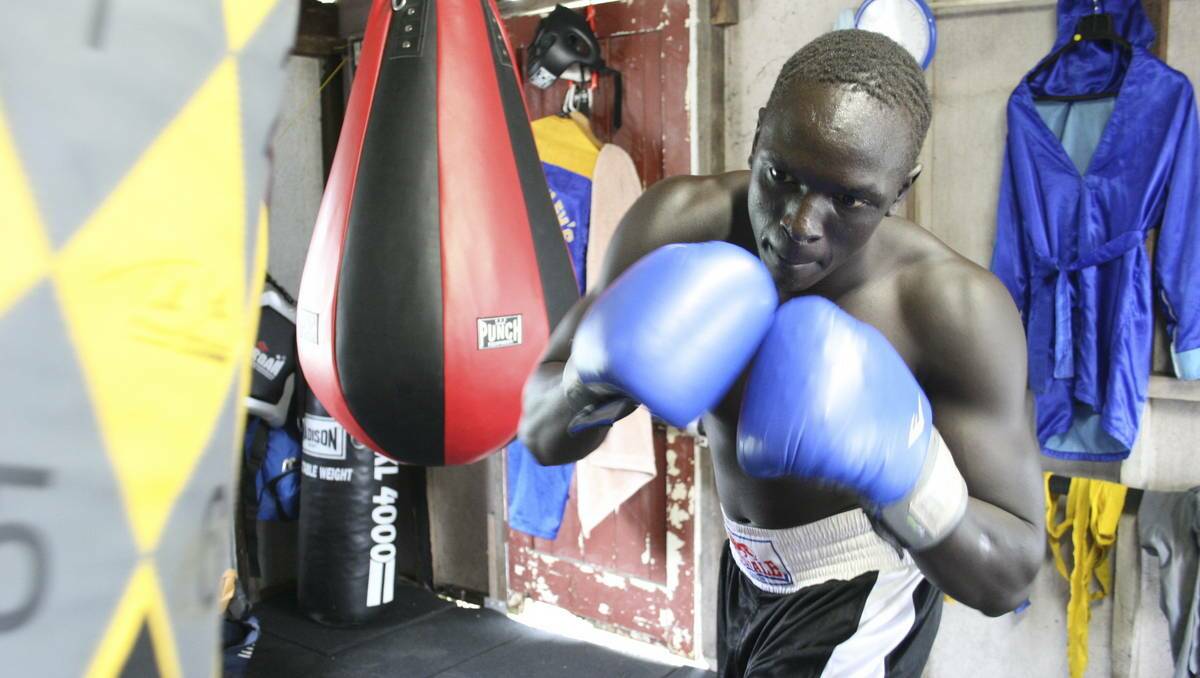 HOMEWORK: Manyang Dut hits the heavy bag in preparation for his Australian amateur title fight. Picture: David Stewart